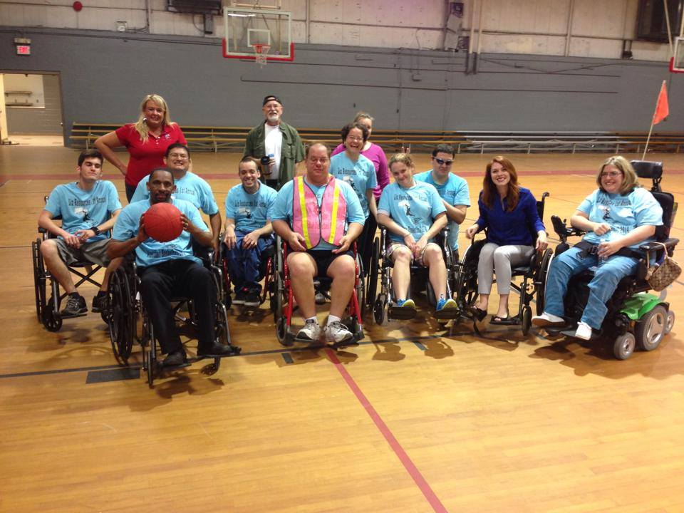 Individuals with disabilities participating in community basketball team activity